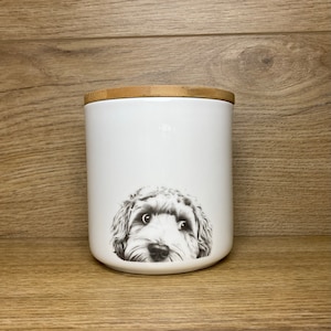 May include: White ceramic canister with a bamboo lid. A black and white illustration of a dog's face is printed on the front of the canister.