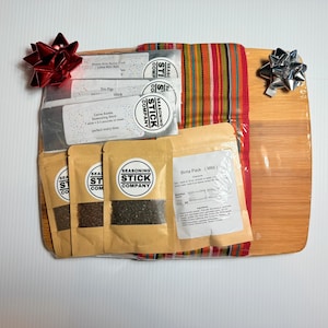 gift for the cook comes with 3 flavors of smoked sea salt, Carne Asada seasoning, tri-tip seasoning, sweet and spicy rim salt & bamboo board