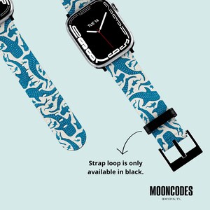 May include: White watch strap featuring a blue whale design, attached to a black Apple Watch. The strap loop is only available in black. The brand name "MOONCODES" is visible.