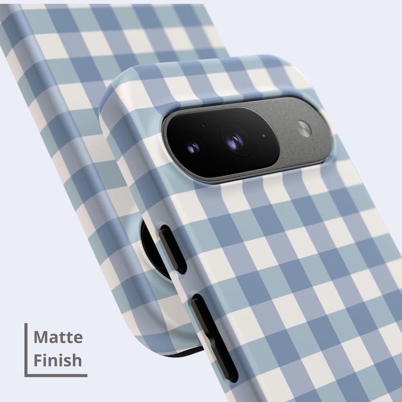 May include: A phone case with a light blue and white gingham check pattern and a matte finish. The case features a cutout for a dual-lens camera system and black side buttons. The text "Matte Finish" is visible in the lower left corner.