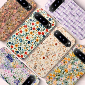 May include: A collection of floral patterned phone cases. Designs include a variety of flowers in red, blue, orange, and yellow, set against backgrounds of white, beige, and lavender. The cases have a sleek, modern design.