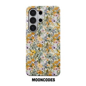 May include: A phone case with a floral pattern in shades of yellow, purple, and green. The case has a camera module with three lenses and the text "MOONCODES" at the bottom.