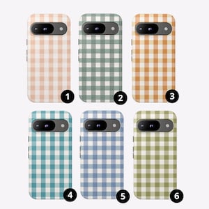 May include: Six smartphone cases arranged in two rows, each featuring a distinct gingham check pattern in pastel peach, sage green, mustard yellow, teal, periwinkle blue, and olive green. Each case has a black horizontal camera module.