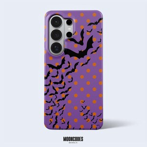 May include: A purple smartphone case featuring a pattern of orange polka dots and numerous black bat silhouettes of varying sizes. The case has a cutout for a multi-lens camera system on the upper left side. The text MOONCODES HOUSTON, TX is visible.