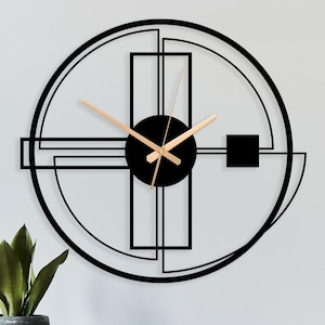 May include: A modern black wall clock with a geometric design, featuring a circular outline and rectangular shapes. The clock has light brown hands and a black central disc. It's mounted on a white wall above a black console.