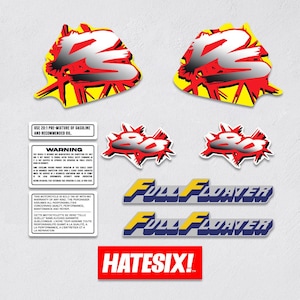 May include: A collection of motorcycle decals and warning labels. The decals feature a stylized "Z" design in red, white, and black on a yellow background. Other decals include "800" and "Full Floater" text. A red and white label reads "HATESIX!"