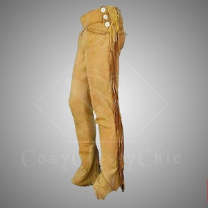 May include: Tan leather pants with fringe detail and button accents.