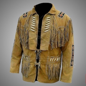 May include: Tan suede jacket with fringe detailing, decorative beading, and bone-coloured accents. The jacket features a collared neckline, front pockets, and a tie closure. The sleeves and chest have fringe.