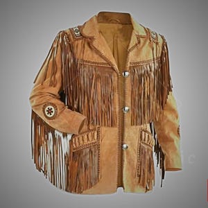 May include: A tan suede jacket with long fringe detailing on the sleeves, chest, and pockets. The jacket features decorative beading on the shoulders and sleeves, and silver-tone buttons. A classic Western-style garment.