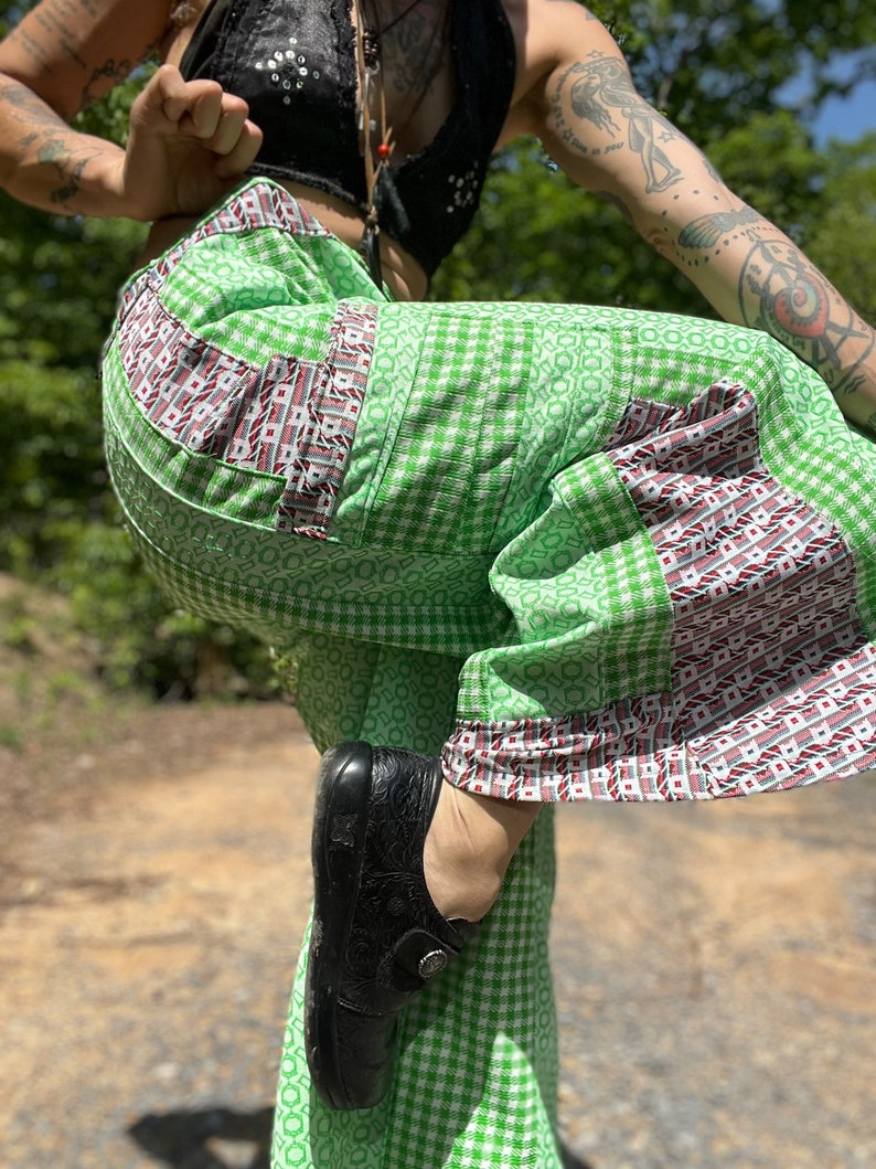 May include: Green and white checkered pants with red and white trim. The pants are made of a lightweight fabric and have a wide leg.