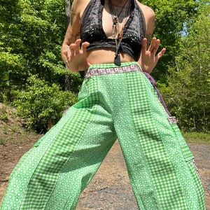 May include: Green and white checkered wide-leg pants with a patterned waistband and a large pocket on the right leg.