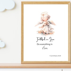 May include: A framed print with a watercolor illustration of an angel with a halo, holding a flower. The text below the image reads "Faithful in Love Do everything in Love. 1 Corinthians 16:14"