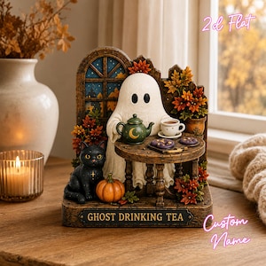 May include: A decorative figurine featuring a white ghost sitting at a small round table with a green teapot, a teacup, and cookies. A black cat and an orange pumpkin sit nearby. The base is labeled GHOST DRINKING TEA, surrounded by autumn foliage.