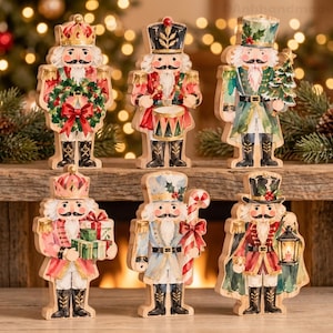 May include: A set of six wooden nutcracker figurines featuring various festive designs, including one holding a wreath, one playing a drum, one with a tree, one carrying gifts, one with a candy cane, and one holding a lantern, all with painted details.