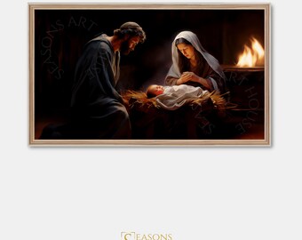 May include: A framed artwork depicting the Nativity scene. The image shows Mary and Joseph gazing at the baby Jesus in a manger, with a fire in the background. The artwork is framed in a light brown wooden frame.