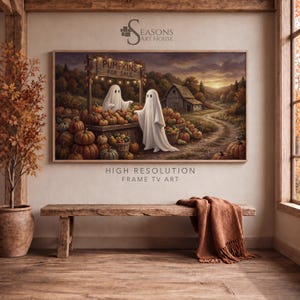 May include: A rectangular wall art print featuring a landscape scene with two white ghosts at a wooden stand labeled PUMPKINS FOR SALE. The scene includes numerous orange pumpkins, a rustic barn, and a dirt path under a sunset sky with autumn trees.