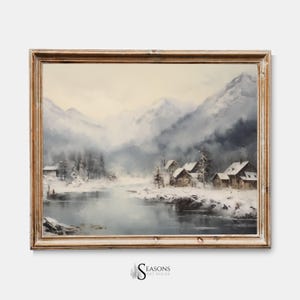 May include: A framed painting depicting a winter scene with snow-covered mountains, a frozen lake, and small wooden houses. The sky is a soft blue with wispy clouds.