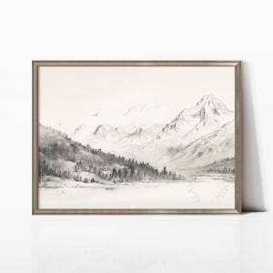 May include: A framed landscape art print depicting a mountain scene in monochrome tones. The artwork shows a mountain range, a lake, and trees, with birds in the sky. The print is set within a wooden frame.