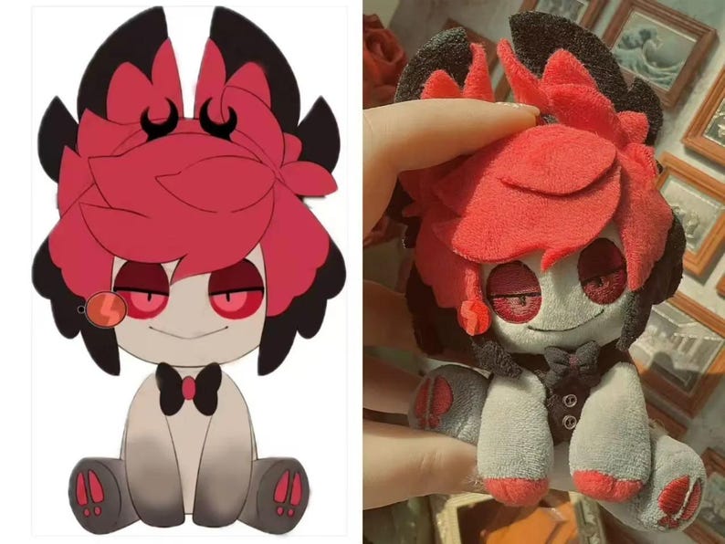 May include: A plush doll with a cartoon design. The doll has a red and black head with large, petal-like shapes, red eyes, and a small smile. It wears a black bow tie and a gray vest. The doll's body is primarily gray and white.