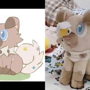 May include: A plush toy dog with light brown fur, blue eyes, and a white and tan collar. The dog has a bee attached to its face. The toy is sitting on a patterned blanket.