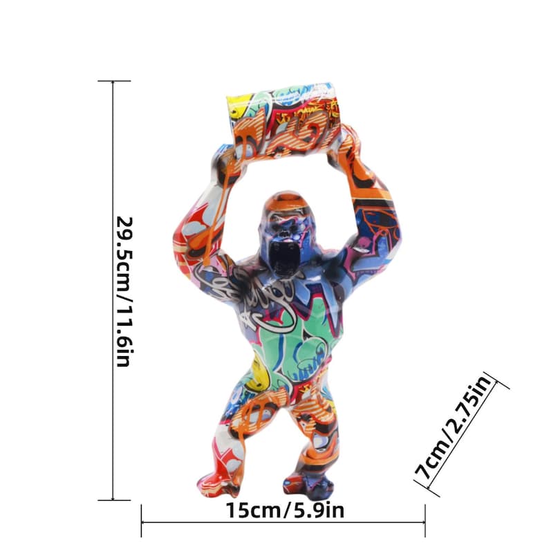 May include: A gorilla figurine covered in colorful graffiti patterns, holding a cylindrical object overhead. The figure measures 11.6 inches in height, 5.9 inches in width, and 2.75 inches in depth, as indicated by the visible measurement lines.