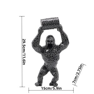 May include: A black and white crackle-patterned gorilla figurine holding a cylinder above its head. The figure measures 11.6 inches in height, 5.9 inches in width, and 2.75 inches in depth as indicated by the visible dimension lines.