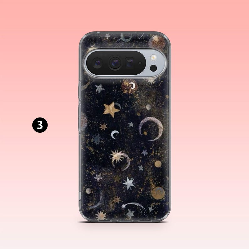 May include: A phone case with a celestial design. The case features a dark background with gold and silver stars, moons, and other celestial elements. The phone's camera is visible at the top. The number "3" is in a black circle in the upper left corner.