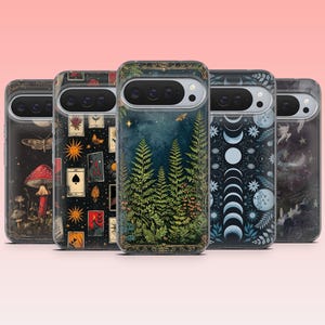 May include: A collection of phone cases with various designs. One case features a mushroom and moth illustration, another showcases tarot cards and suns, and a third displays a forest scene. The cases have a dark, mystical aesthetic.