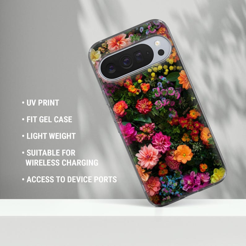 May include: A phone case with a colourful floral pattern, including pink, orange, and yellow blooms. The case has a clear edge and text: UV PRINT, FIT GEL CASE, LIGHT WEIGHT, SUITABLE FOR WIRELESS CHARGING, and ACCESS TO DEVICE PORTS.