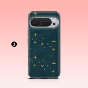 May include: A teal phone case with a constellation of gold stars. The case has a clear border and a camera cutout. The background is a gradient of pink and peach.