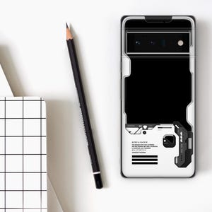 May include: A white phone case with a black and white geometric design, a black rectangle, and a black and gray accent. A black pencil and a white notebook with a grid pattern are also in the image.