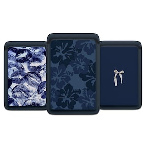 May include: Three rectangular tablet sleeves with dark blue borders. The left sleeve features a blue and white lip print pattern. The center sleeve displays a dark blue hibiscus floral design. The right sleeve is solid navy blue with a small white bow.