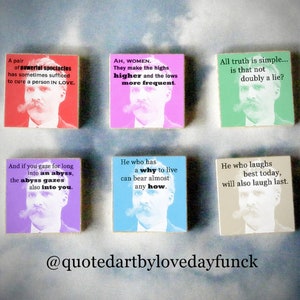 May include: Six colourful square wooden signs with inspirational quotes and illustrations of a man with a moustache. The quotes are: "A pair of powerial spectacles has sometimes sufficed to cure a person IN LOVE.", "AH, WOMEN. They make the highs higher and the lows more frequent", "All truth is simple... is that not doubly a lie?", "And if you gaze for long into an abyss, the abyss gazes also into you.", "He who has a why to live can bear almost any how.", "He who laughs best today, will also laugh last."