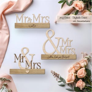 Op de afbeelding: Drie houten Mr. & Mrs. borden met een lichte houten afwerking. De borden staan op rechthoekige voetstukken, één met een oneindigheidssymbool, een ander met een hart en de derde met de tekst "Alles Liebe zur Hochzeit!"