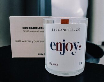 A scented candle from a special collection with a motivational sticker "Enjoy!". The perfect gift for any occasion.