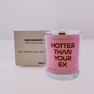 A scented soy candle with a funny sticker &#39;Hotter Than Your EX&#39;. The perfect gift for her, for your friend and for him.