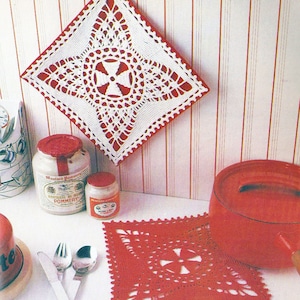 May include: Two crocheted pot holders, one white with a red centre and one red with a white centre. Both pot holders are square shaped with a decorative design.
