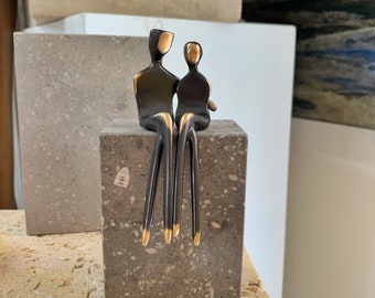 Caress | Elegant bronze sculpture of a loving couple  |  perfect anniversary gift for your partner on a gray limestone