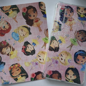May include: Pink accessories with cartoon illustrations of princesses in ballet outfits. The items include a tablet cover and a phone case. The designs feature various princesses with different skin tones and hair colours, wearing tutus and ballet shoes.