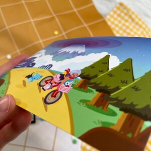 Może przedstawiać: Kolorowa ilustracja przedstawia postaci z kresk&oacute;wek jadące na rowerze przez krajobraz z drzewami i g&oacute;rą. Grafika charakteryzuje się jasnymi kolorami i kresk&oacute;wkowym stylem, skupiając się na postaciach i ich podr&oacute;ży.