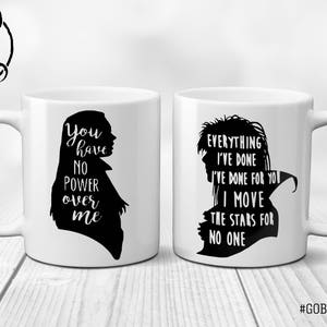 May include: Two white ceramic mugs with black silhouettes and text. The mug on the left says "You have no power over me". The mug on the right says "Everything I've done I've done for you I move the stars for no one".