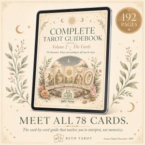 May include: A digital tablet displaying a tarot guidebook. The cover reads "COMPLETE TAROT GUIDEBOOK Volume 2 - The Cards." The image features illustrations of tarot cards, floral accents, and the text "MEET ALL 78 CARDS." The digital download is 192 pages.