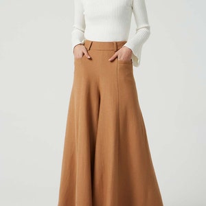 May include: A brown wide-leg pant with a high waist and pockets. The pant is made of a soft, textured fabric.