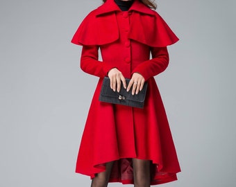 May include: A red wool coat with a cape collar and a high neckline. The coat has a fitted bodice and a flared skirt. The model is wearing black tights and black boots.
