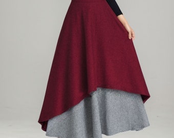 May include: A woman wearing a black turtleneck sweater and a burgundy and white patterned skirt. The skirt is a-line and has a high waist.