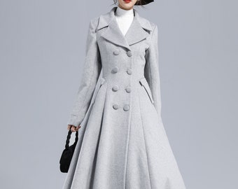May include: A gray double-breasted wool coat with a flared skirt and a black hat.