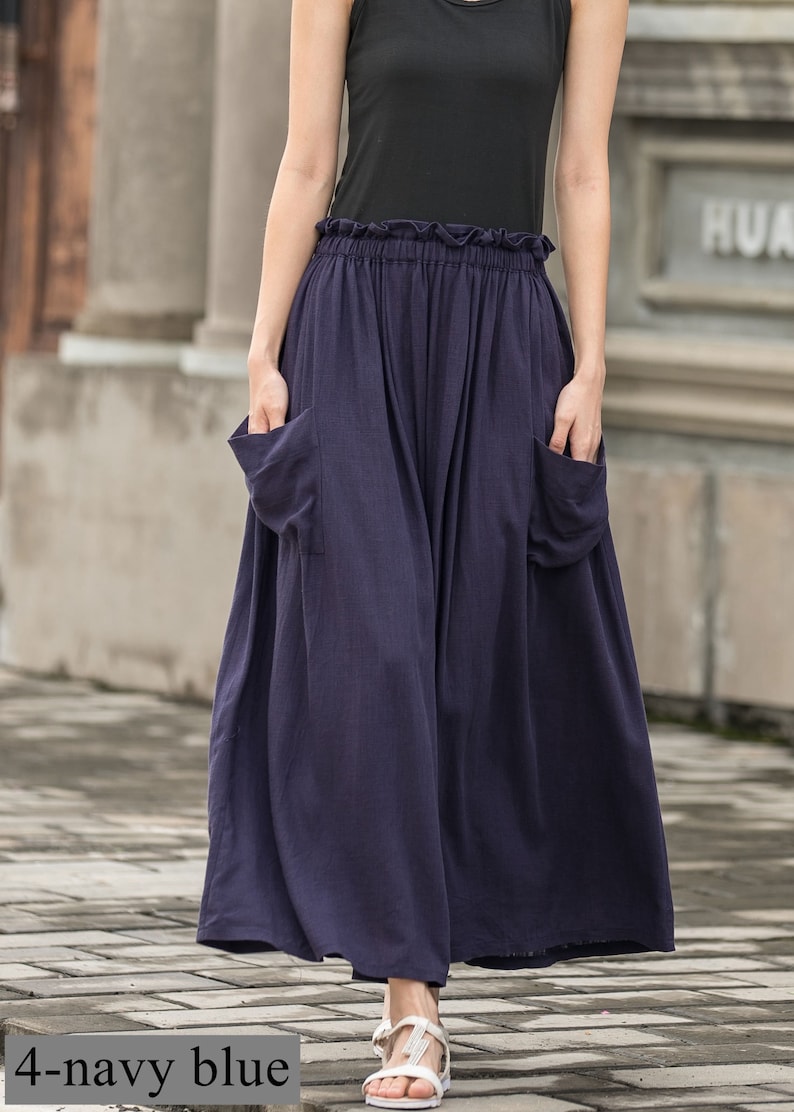 May include: Navy blue wide-leg pants with large front pockets and a ruffled waistband. The pants are made of a flowing fabric and are paired with a black top. The text "4-navy blue" is visible at the bottom of the image.