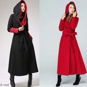 May include: Two long hooded coats, one black with red lining and one red. Both coats have a double-breasted closure, a belt, and a large hood.