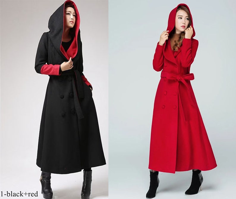 May include: Two long hooded coats, one black with red lining and one red. Both coats have a double-breasted closure, a belt, and a large hood.