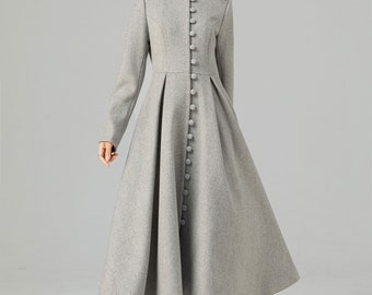 May include: A gray long-sleeved coat with a high collar and a row of buttons down the front. The coat has a flared skirt and is made of a soft, warm fabric.